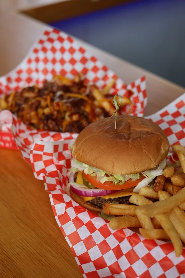 A burger and fries in a checkered basket at Brickopolis