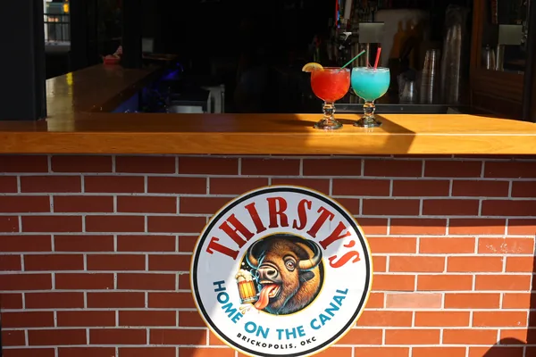 The Thirsty's Dockside Bar counter with two cocktails on the rail