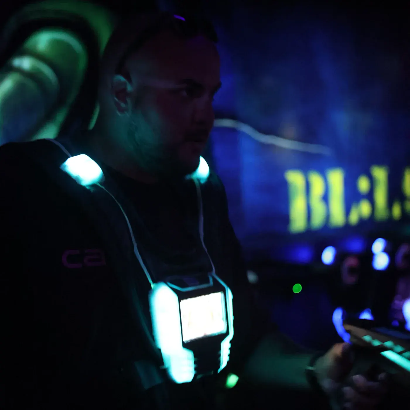 A vest and marker lit up in the dark arena